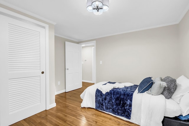 bedroom featuring hardwood / wood-style floors and crown molding