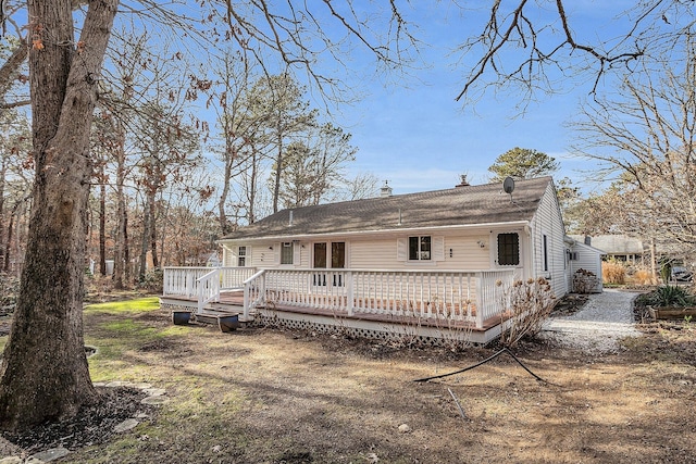 rear view of house featuring a wooden deck