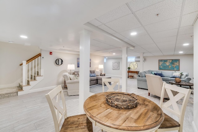 dining room featuring stairs, a drop ceiling, baseboards, and recessed lighting