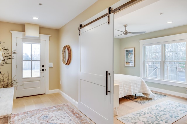 entrance foyer with plenty of natural light, a barn door, baseboards, and recessed lighting