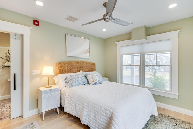 bedroom with light wood finished floors, baseboards, visible vents, and recessed lighting