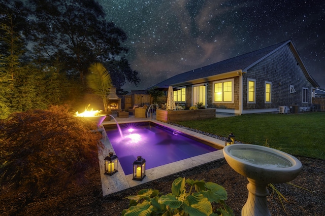 outdoor pool with a patio, a lawn, an outdoor hangout area, and fence