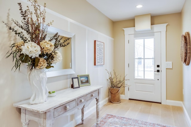 doorway to outside featuring baseboards and recessed lighting