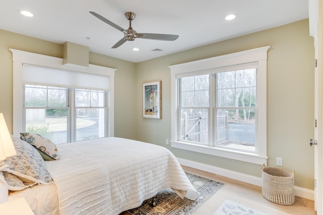 bedroom featuring recessed lighting, multiple windows, and baseboards