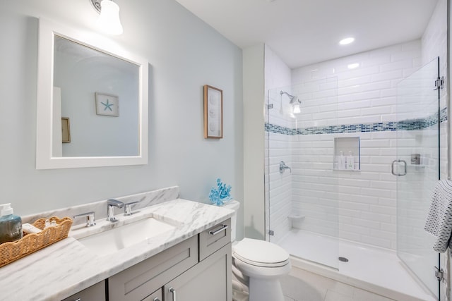 bathroom featuring recessed lighting, a shower stall, toilet, and vanity