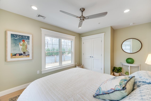 bedroom featuring recessed lighting, visible vents, a ceiling fan, wood finished floors, and baseboards