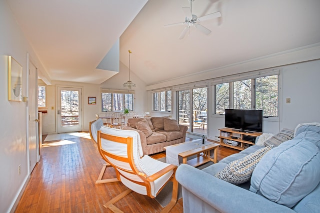 living room with high vaulted ceiling, baseboards, light wood finished floors, and a ceiling fan