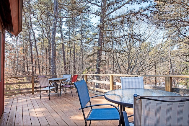 wooden terrace with outdoor dining space