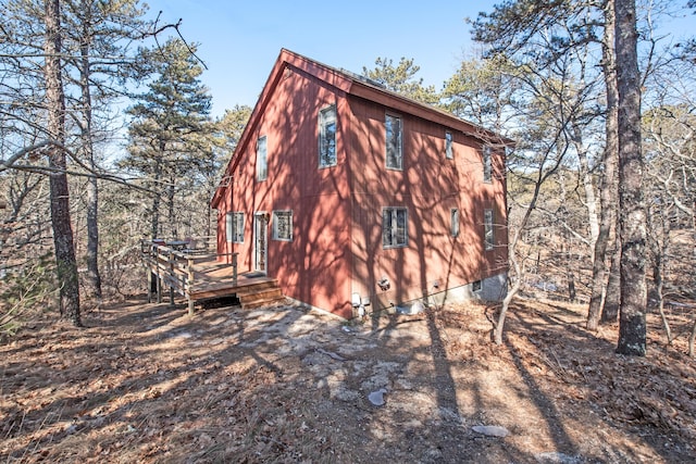 view of property exterior featuring a wooden deck