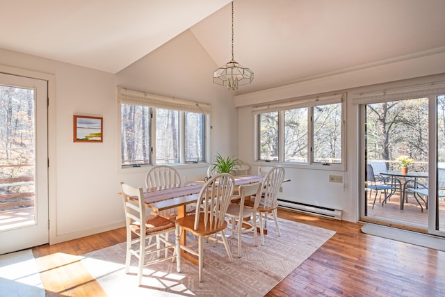 dining area featuring light wood finished floors, a baseboard radiator, and a wealth of natural light