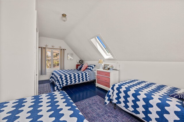 bedroom with vaulted ceiling with skylight