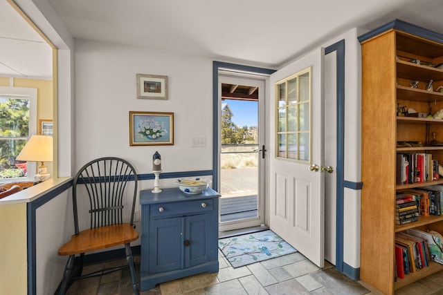 doorway featuring a wealth of natural light and stone tile flooring