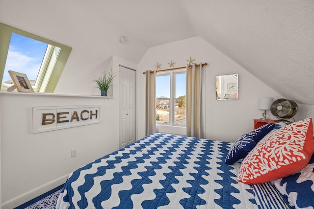 bedroom with vaulted ceiling and baseboards