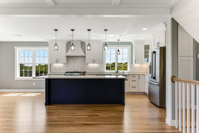 29 Sheppard Rd, Sagamore Beach, MA 02562 - kitchen featuring high end fridge, custom range hood, light wood-type flooring, light countertops, and tasteful backsplash