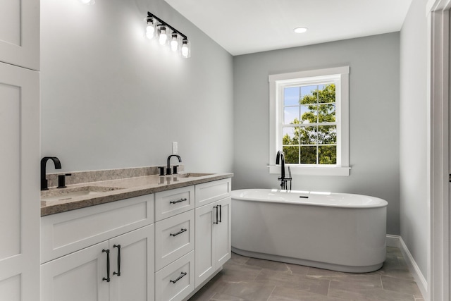 29 Sheppard Rd, Sagamore Beach, MA 02562 - full bath featuring a soaking tub, double vanity, and baseboards