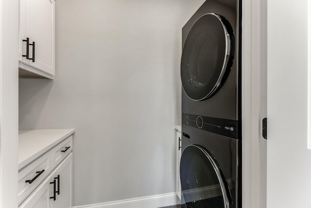 29 Sheppard Rd, Sagamore Beach, MA 02562 - washroom featuring stacked washer and clothes dryer, cabinet space, and baseboards