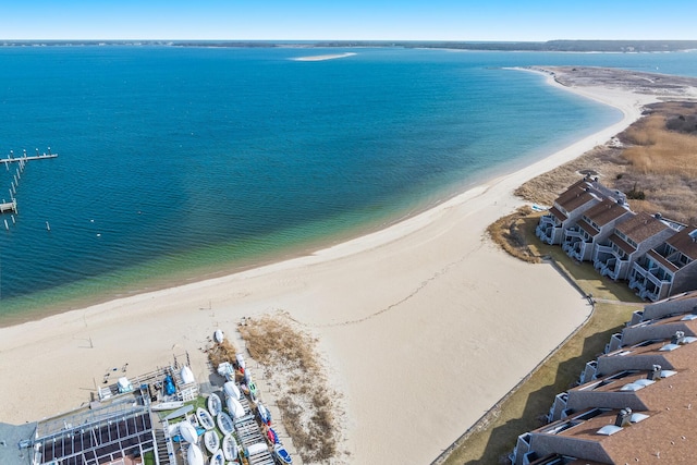 birds eye view of property with a water view and a beach view