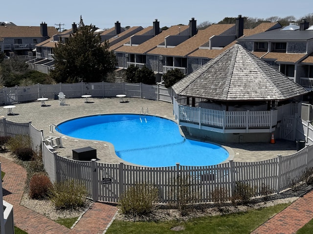 community pool featuring a residential view, fence private yard, and a patio area