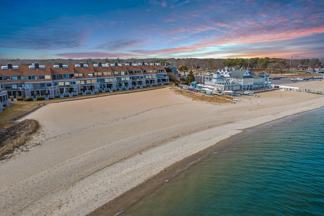 bird's eye view featuring a view of the beach and a water view