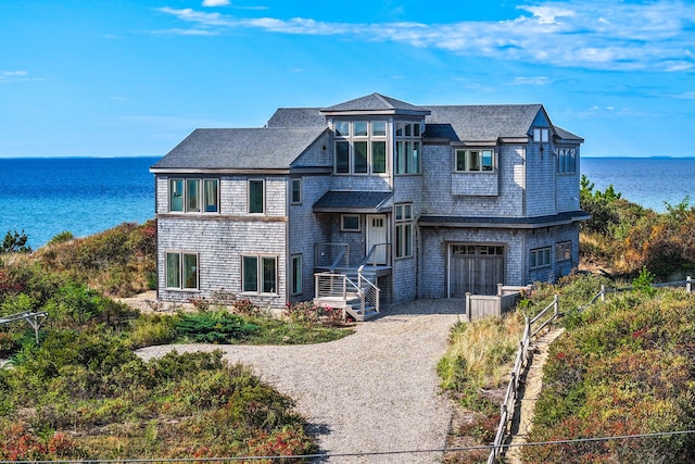 view of front of house featuring a garage and a water view