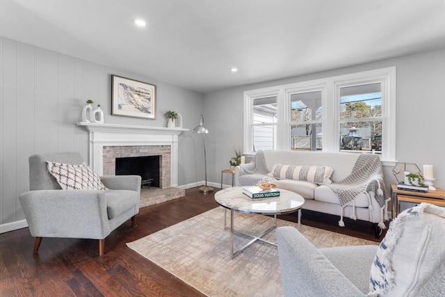 living room with recessed lighting, a fireplace, baseboards, and wood finished floors