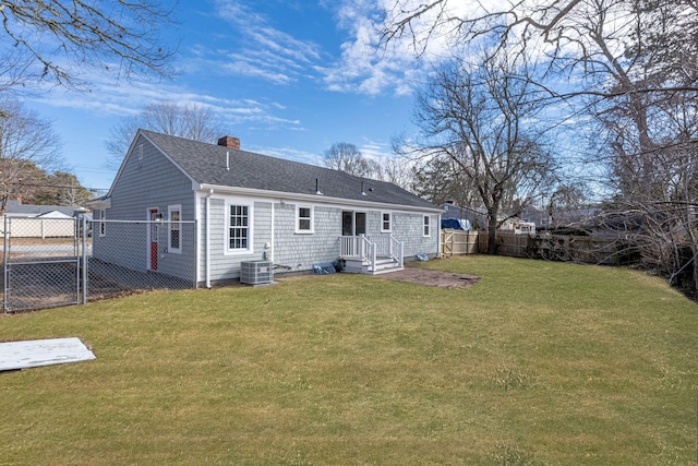 rear view of property with a fenced backyard, a gate, a chimney, and a lawn