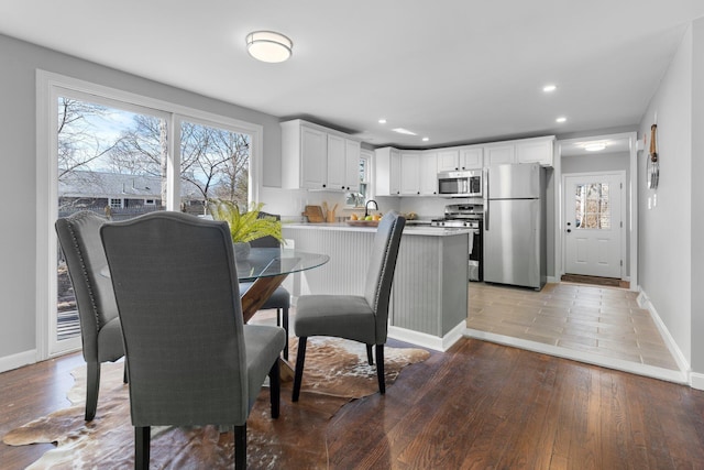 dining area featuring plenty of natural light, light wood-style flooring, and recessed lighting