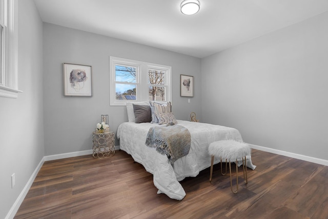 bedroom featuring baseboards and wood finished floors