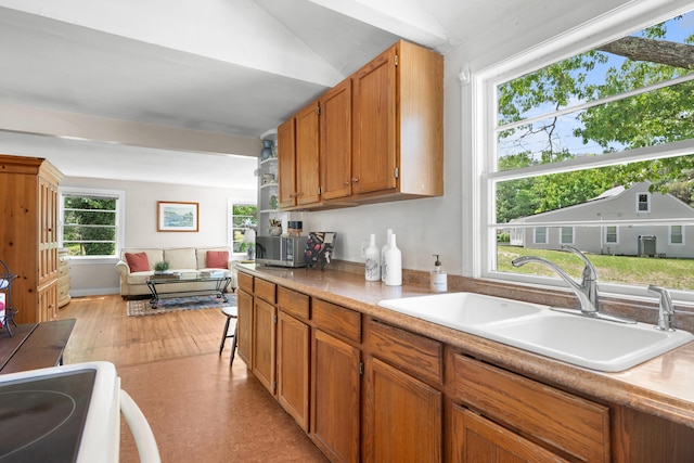 22 Wallace Pt, Buzzards Bay, MA 02532 - kitchen featuring a sink, light countertops, brown cabinetry, light wood-style floors, and range