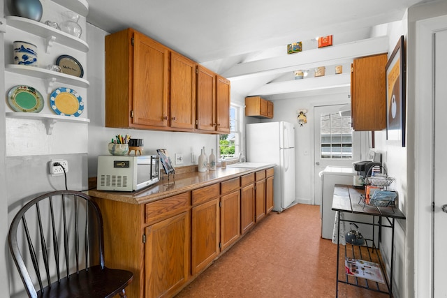 22 Wallace Pt, Buzzards Bay, MA 02532 - kitchen featuring white appliances, open shelves, light flooring, brown cabinetry, and washer / dryer