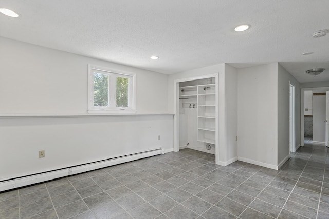 3 Waterside Dr, North Falmouth, MA 02556 - unfurnished bedroom featuring a baseboard radiator, a textured ceiling, recessed lighting, tile patterned floors, and a closet