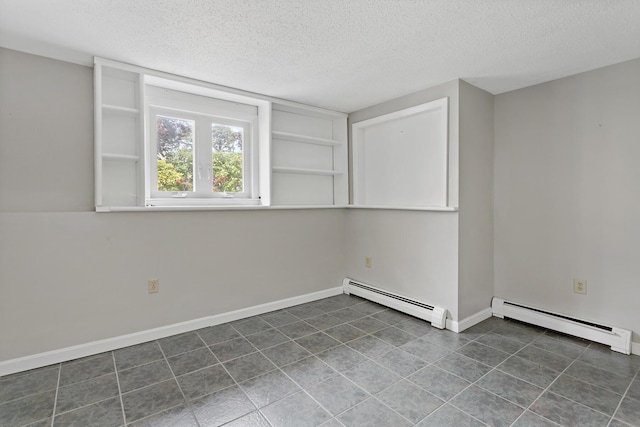 3 Waterside Dr, North Falmouth, MA 02556 - spare room with baseboard heating, a textured ceiling, and dark tile patterned floors