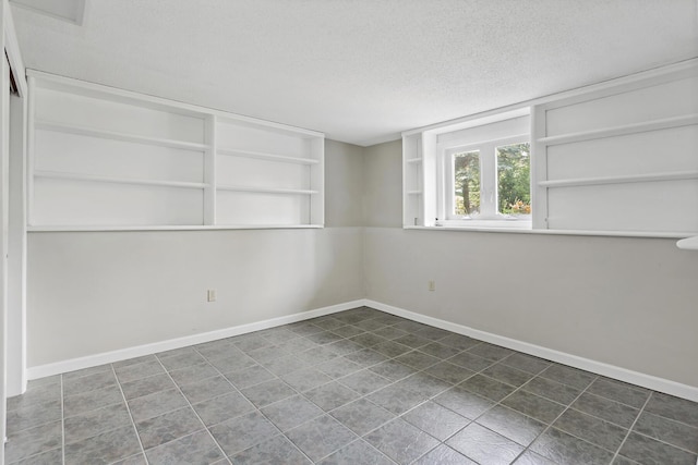 3 Waterside Dr, North Falmouth, MA 02556 - spare room with a textured ceiling, built in features, and tile patterned flooring