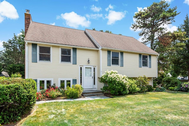 3 Waterside Dr, North Falmouth, MA 02556 - split foyer home with a chimney, a front lawn, and a shingled roof