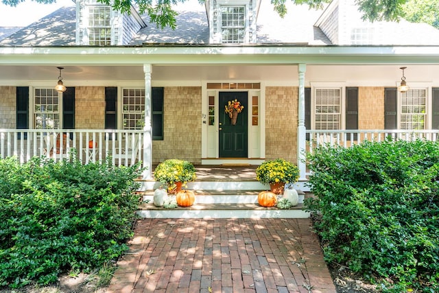 view of exterior entry with a porch