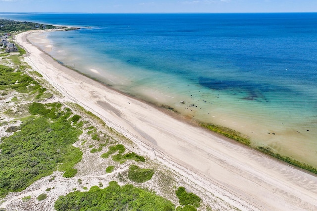 birds eye view of property featuring a beach view and a water view