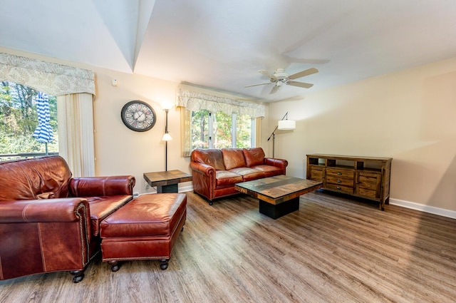 living room featuring ceiling fan and hardwood / wood-style floors