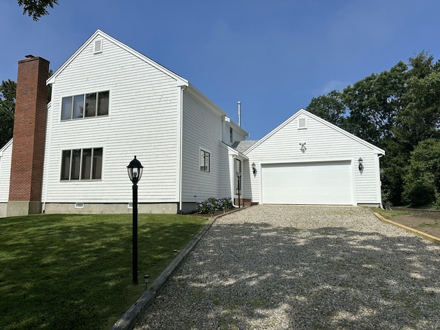 15 Beach St, East Falmouth, MA 02536 - view of home's exterior featuring a yard, an outbuilding, driveway, and a garage