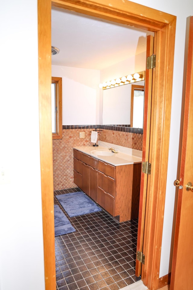 15 Beach St, East Falmouth, MA 02536 - bathroom featuring vanity, tile walls, and wainscoting