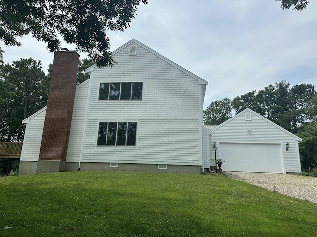 15 Beach St, East Falmouth, MA 02536 - view of property exterior featuring a lawn, a garage, and a chimney