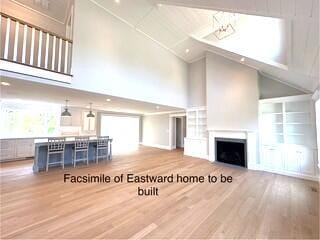 47 Daleys Ter, Orleans, MA 02653 - living room with high vaulted ceiling, wood finished floors, a fireplace, recessed lighting, and built in features