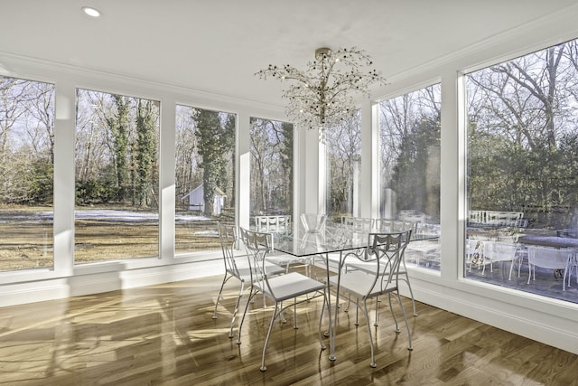 unfurnished sunroom featuring an inviting chandelier