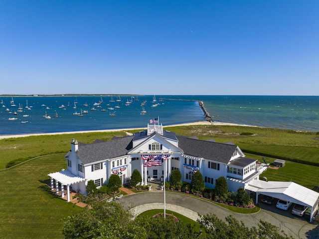 drone / aerial view with a water view and a beach view