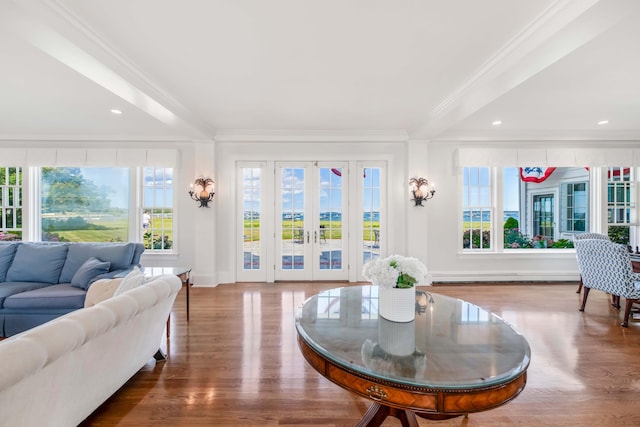 living room with hardwood / wood-style flooring and crown molding