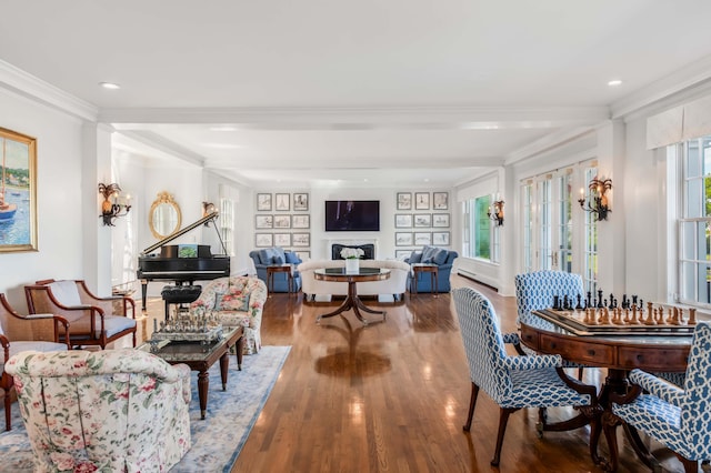 dining area with hardwood / wood-style floors, crown molding, and a healthy amount of sunlight