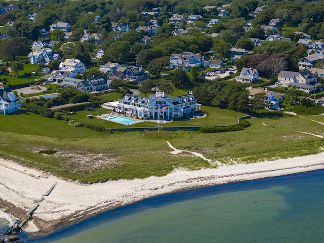 birds eye view of property featuring a beach view and a water view