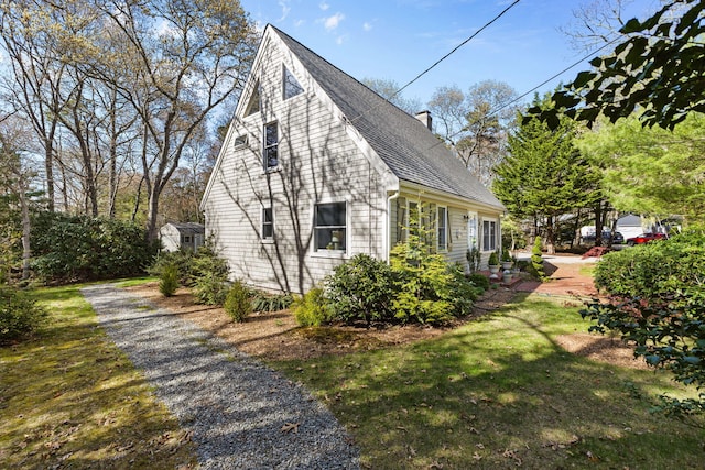 11 White Oak Trl, Centerville, MA 02632 - view of home's exterior with a chimney, a shingled roof, and a yard