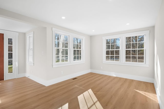 empty room with hardwood / wood-style flooring