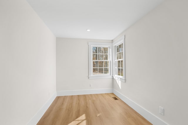 spare room with light hardwood / wood-style floors