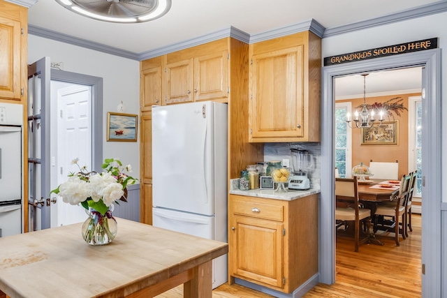 43 Owl Pond Rd, Brewster, MA 02631 - kitchen with white appliances, light wood-style floors, a chandelier, light countertops, and crown molding